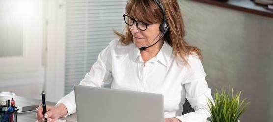 Bild: Frau mit Headset am Laptop