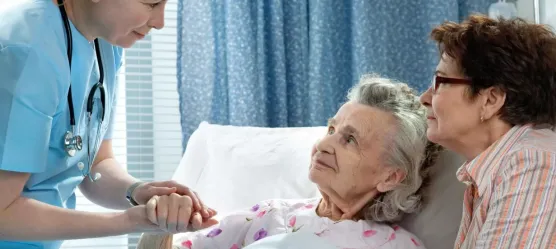 Bild Pflegerin hält Hand einer Patientin